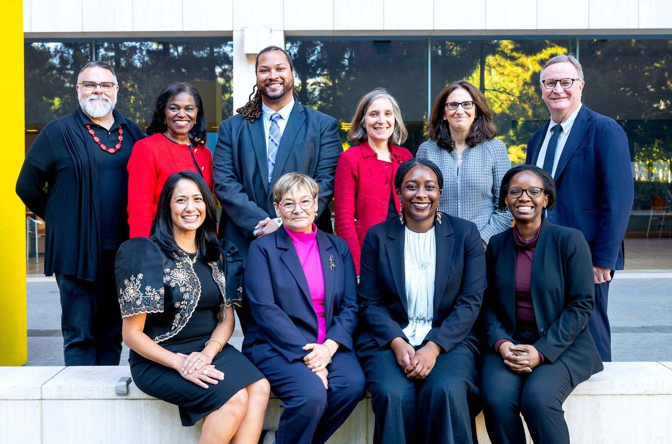 Group of working professionals posing in a close group.