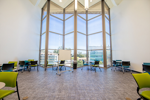 Science Library 5th Floor Study Space with large window and tables and chairs
