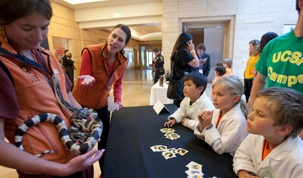 California Academy of Sciences staff show a Northern Pine Snake to children California Academy of Sciences staff show a Northern Pine Snake to children