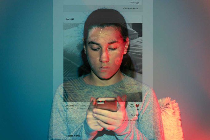 A pre-teenage girl looks at social media on her phone with a serious expression. Reflected in the wall behind her is the platform she is looking at.