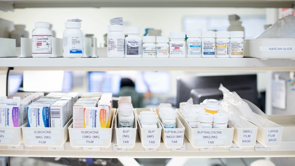 Two rows of pill bottles containing medications that treat opioid addiction