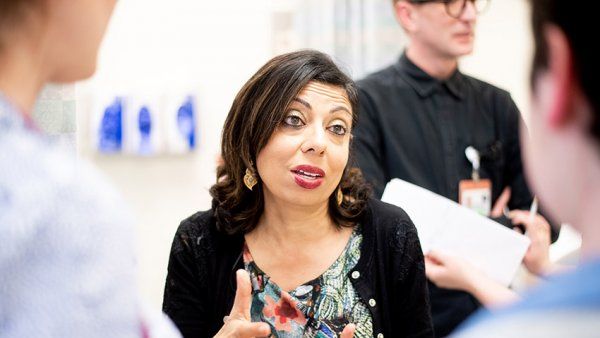 Monica Gandhi speaking with colleagues at the POP UP clinic