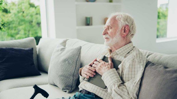 older man napping on couch