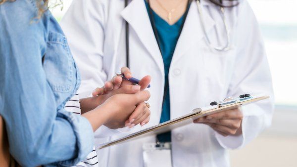 Doctor comforting woman