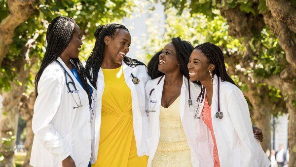 four women smile and laugh