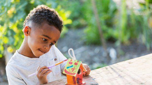 child painting small bird house