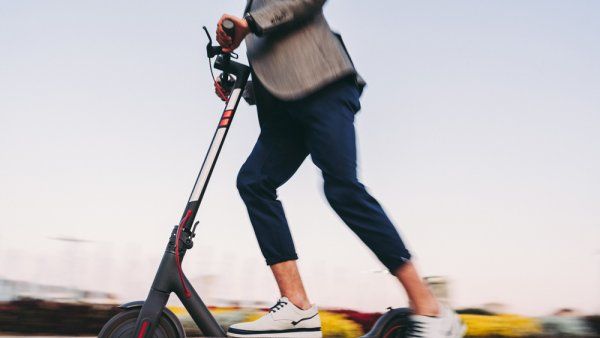 man riding an e-scooter