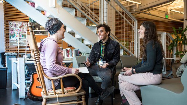 Three people sitting and talking