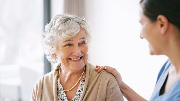 older woman and a nurse, smiling