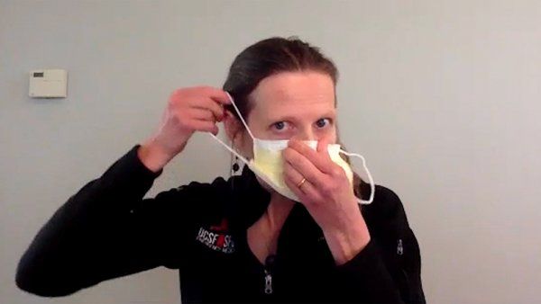 Woman putting on a surgical mask