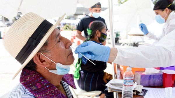 Man wearing hat gets a nose swab