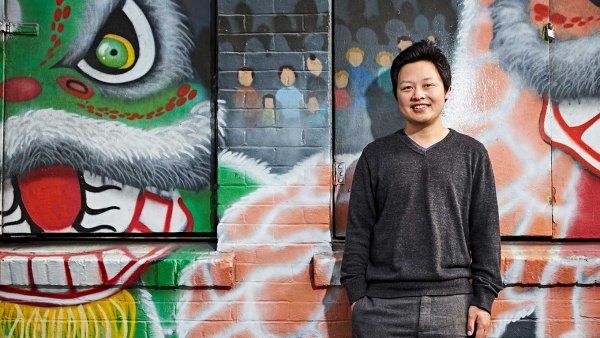 Photo of Richard Feng, MD, in front of a mural of painted dragons, in Chinatown, San Francisco.