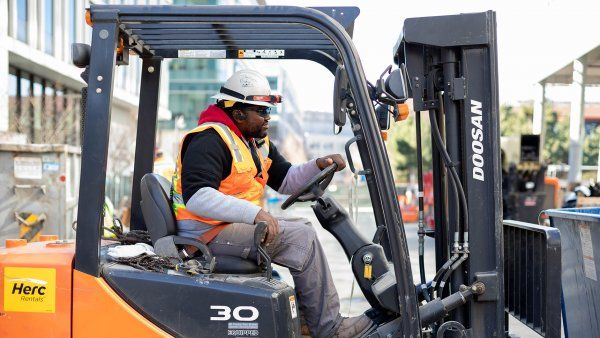 construction worker drives a forklift