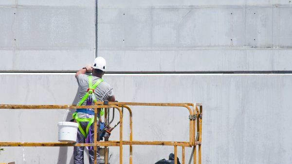 construction worker works with paint 