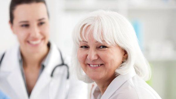 A senior woman with a young female doctor.