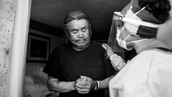 doctor talks with man in a hotel doorway