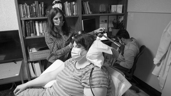 Patient Sarah visits her doctor's office where they check on her deep brain stimulation DBS implant