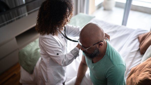 Doctor listening to patient's heart