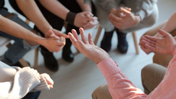 shot of hands from a group of people in discussion