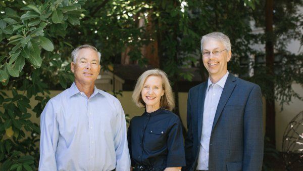 Mike Gordon (left) and his wife, Loren (center), stand with Mark Anderson (right)