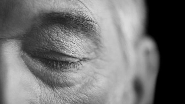 Closeup of an elderly man with eyes closed