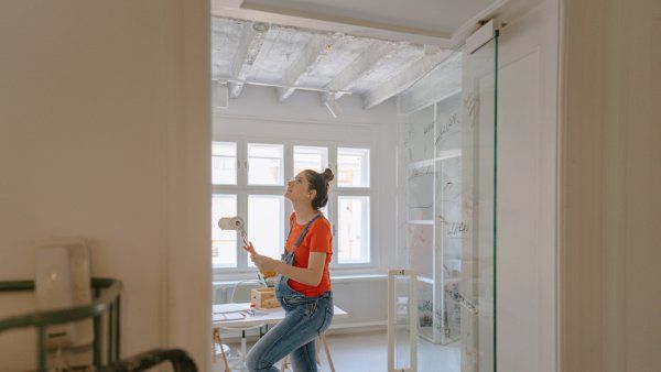 A pregnant woman paints a nursery