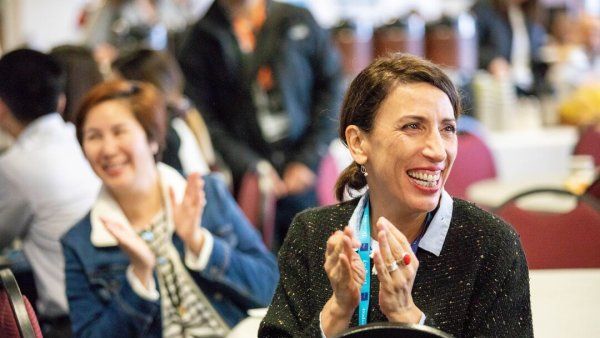 Barbara Sanchez applauds for a raffle winner at a staff appreciation breakfast