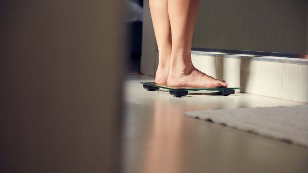 A woman's feet on a scale shown from a distance