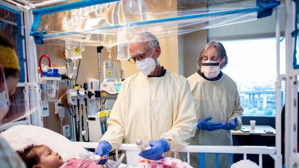 Mort Cowan and Jennifer Puck visit a patient with Artemis-SCID in the hospital who is being treated with their own gene-corrected stem cells