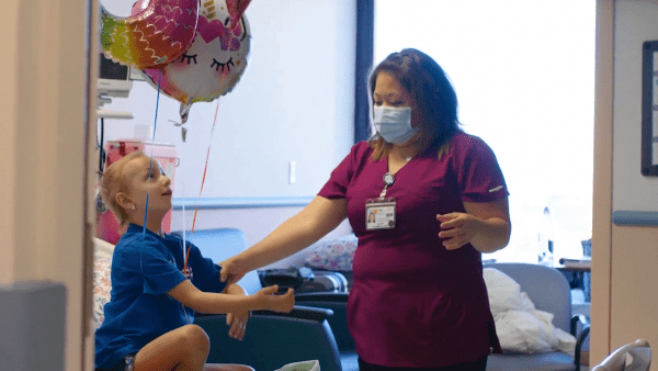 A physical therapist provides therapy and pain management to a young girl.