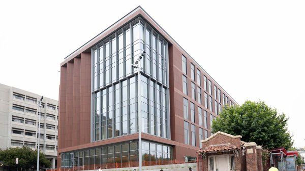 Pedestrians walk past the new Pride Hall building at ZSFG