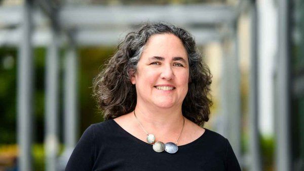 Diana Greene foster stands for a portrait in a hallway at UC Berkeley.