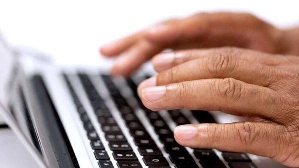 fingers type using employee keyboard at UCSF