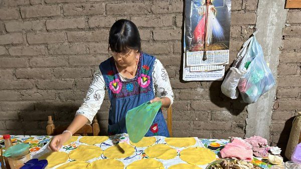 Giselle prepares tortillas for a celebration with a traditional healer and her family.