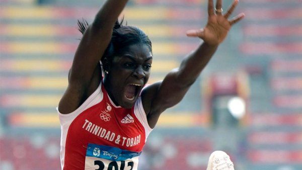 Photo of Rhonda Watkins flying through the air when competing in a long jump.