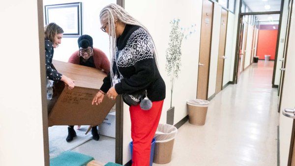 office workers load boxes onto dolly