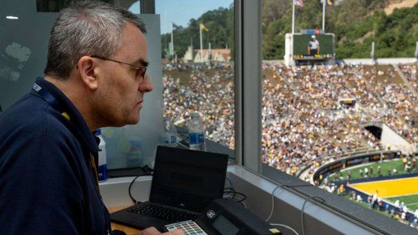 Doug Carlson, who serves as the scoreboard operator for UC Berkeley football games, is depicted working during the season’s opening game between Cal and UC Davis.