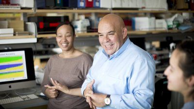 Esteban Burchard speaks with researchers in his Mission Bay lab