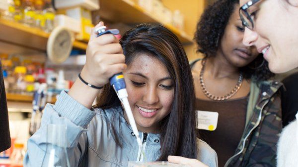 Alyssa Escandor, a student from Burton High School, tries her hand at pippetting in a demonstration in Peter Walter's lab.