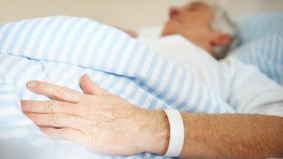 elderly-man-patient-hospital-bed.jpg