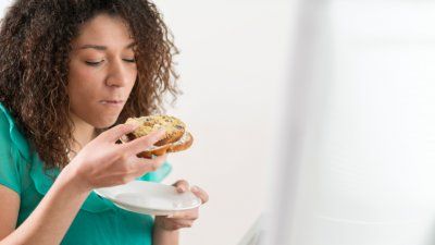 woman-eating-bagel-food-stress.jpg