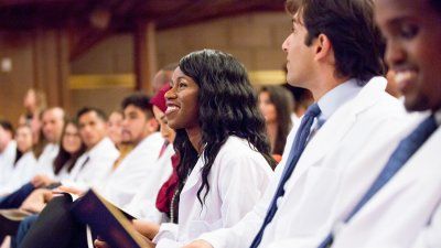 School-Medicine-white-coat-2018-woman-smiling.jpg