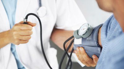 Doctor checking the blood pressure