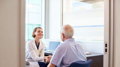 female-doctor-elderly-man-patient-office.jpg