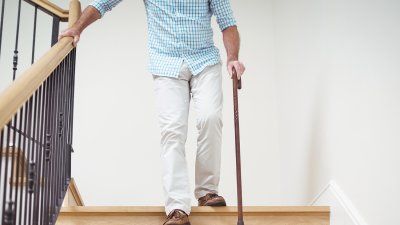 man-walking-stairs-cane.jpg