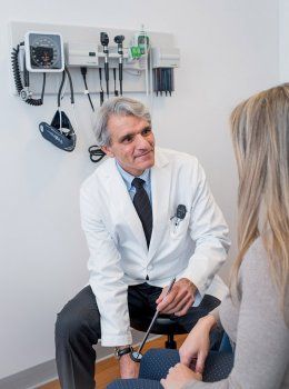 Steve Hauser consults with his patient